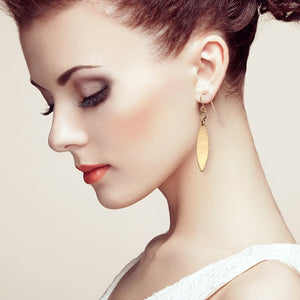 2 of 7: Model Wearing Mini Marquise Hammered Bronze Drop Earrings