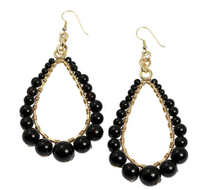 1 of 4: A Pair of Onyx Wire Wrapped 14K Gold-filled Teardrop Earrings on a White Background