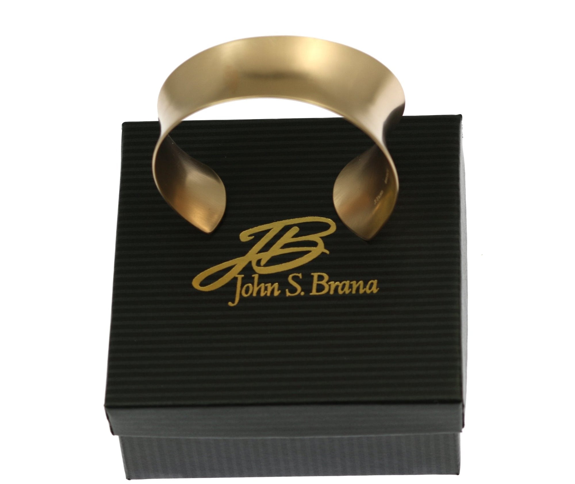 Tapered Brushed Bronze Anticlastic Cuff on Top of a Branded Box