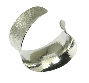 1 of 9: A Texturized Aluminum Anticlastic Bangle on a White Background