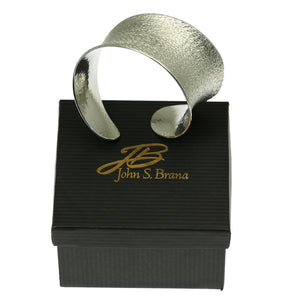 7 of 9: Texturized Aluminum Anticlastic Bangle on Top of a Black Gift Box