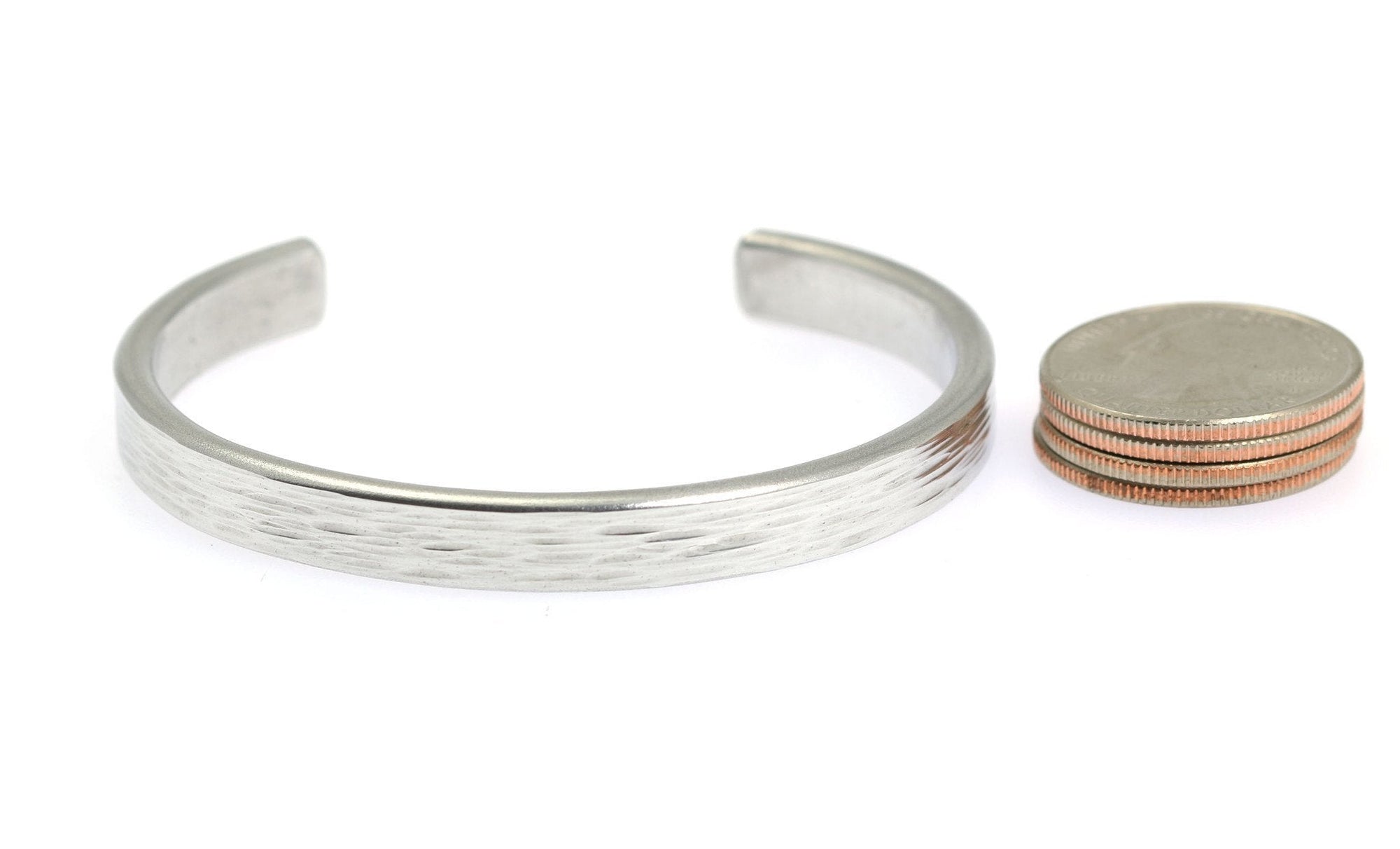 Width of Thin Bark Aluminum Cuff Bracelet compared to a stack of 4 US Quarter Coins