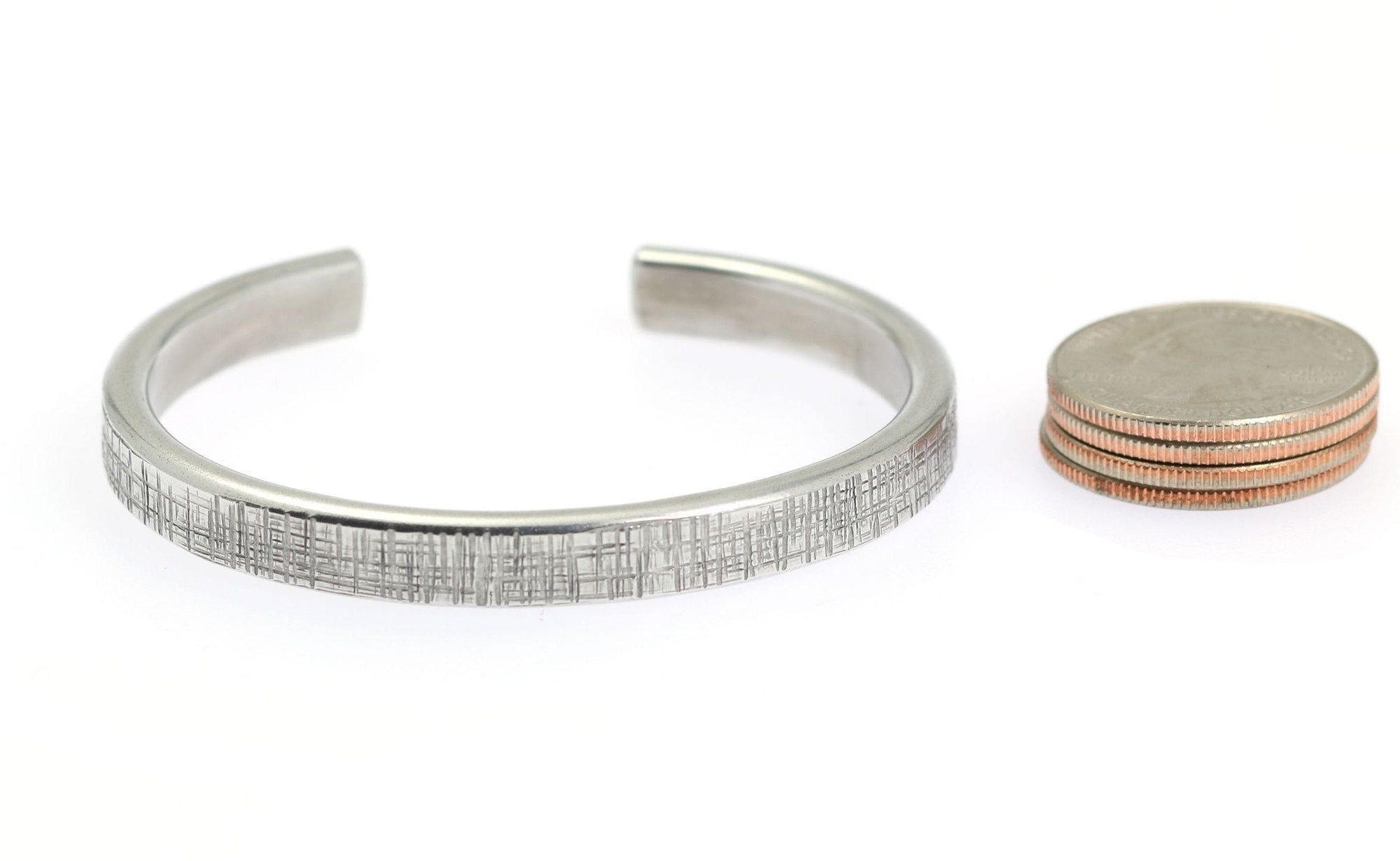 Width of Thin Linen Aluminum Cuff Bracelet compared to a stack of 4 US Quarter Coins