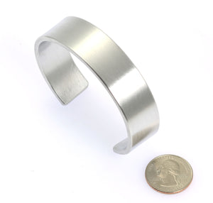 5 of 7: Width of 19mm Brushed Aluminum Cuff Bracelet compared to a US Quarter Coin
