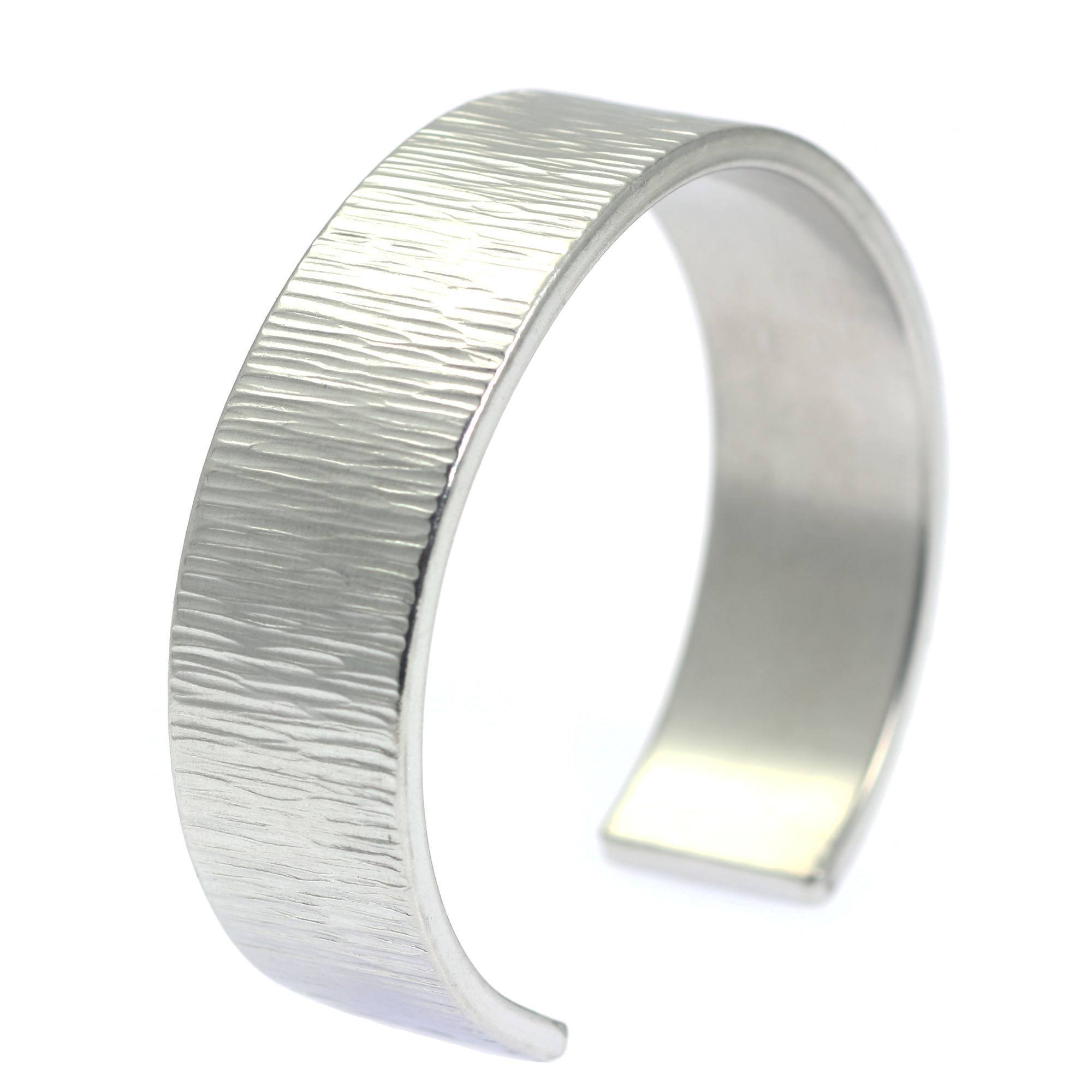 A Chased Aluminum Cuff Bracelet on a White Background