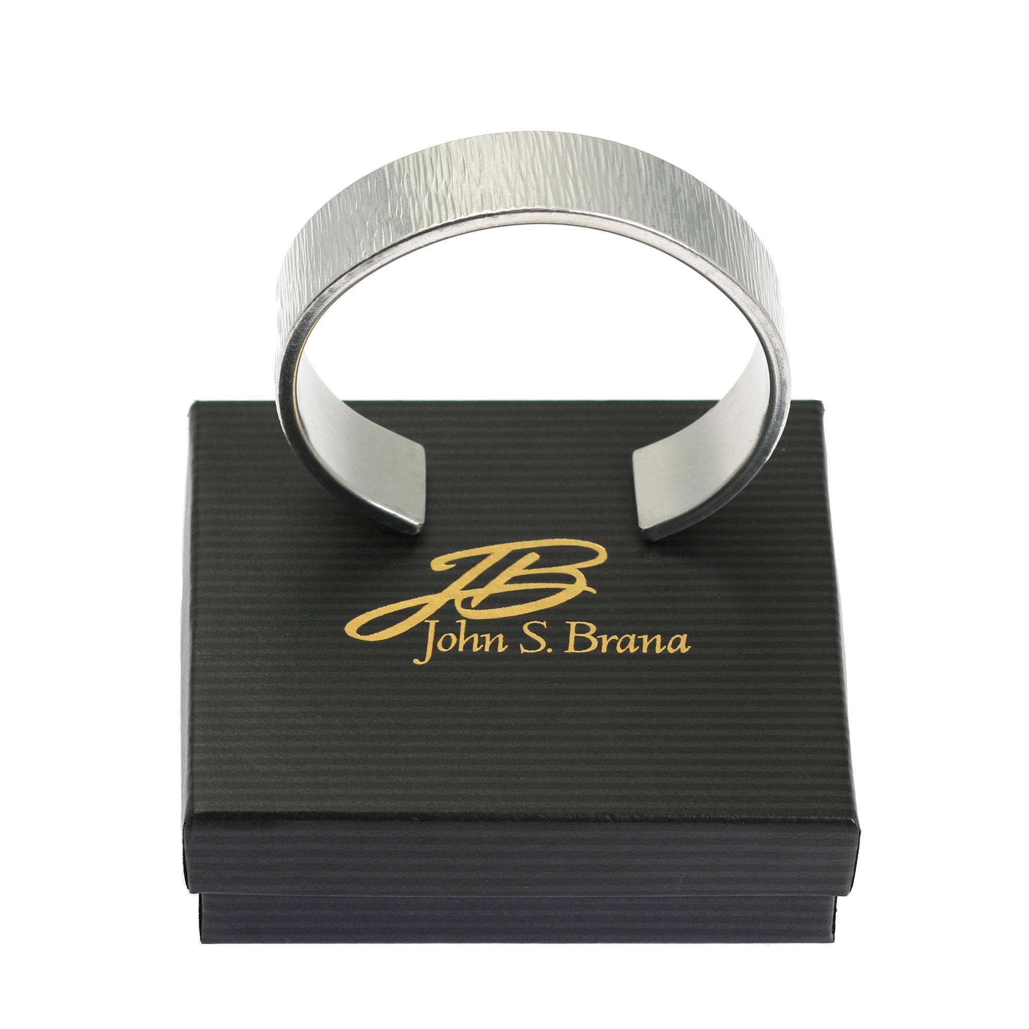 Chased Aluminum Cuff Bracelet on top of a Black Gift Box