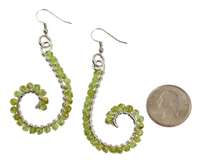 2 of 4: Size of Peridot Wire Wrapped Silver Scroll Earrings compared to a US Quarter Coin